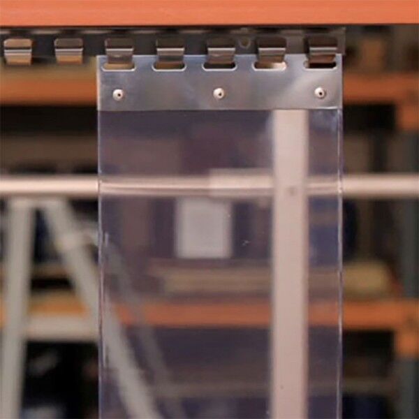 Clear PVC strip curtain hanging from a steel mounting rail