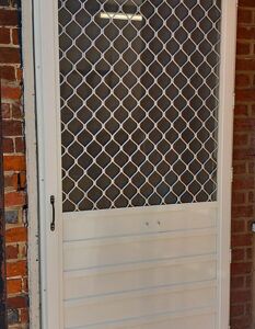 Hinged fly screen door with diamond grille top and solid aluminium lower panel