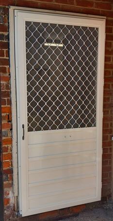 Solid base fly screen door Hinged fly screen door with diamond grille top and solid aluminium lower panel
