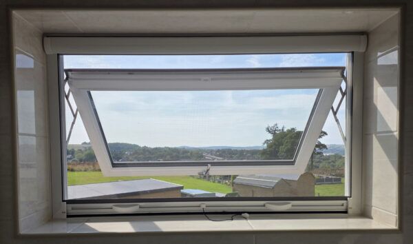 Roller fly screen top hung window Roller fly screen fitted inside a top-hung window
