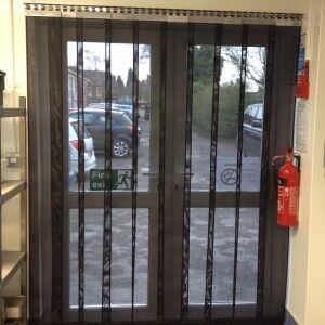 Heavy duty strip mesh fly door across a double doorway