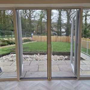French doors with double roller fly screens closed across the opening