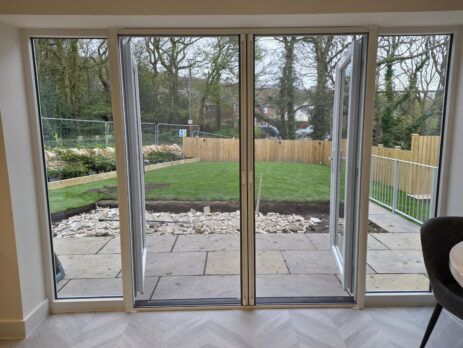 French doors with double roller fly screens closed across the opening